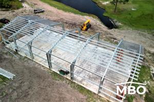 cold formed building in Florida and a lake in the back ground while the building is being erected