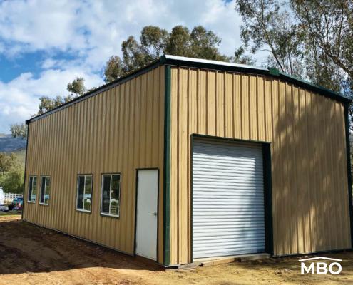 Tan Metal Building with a Garage Door