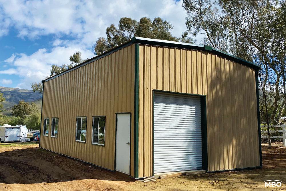 Tan Metal Building with a Garage Door