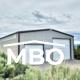 Grey Metal Garage Surrounded by Greenery