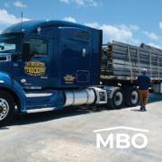 Blue Semi Truck Hauling Steel Building Parts